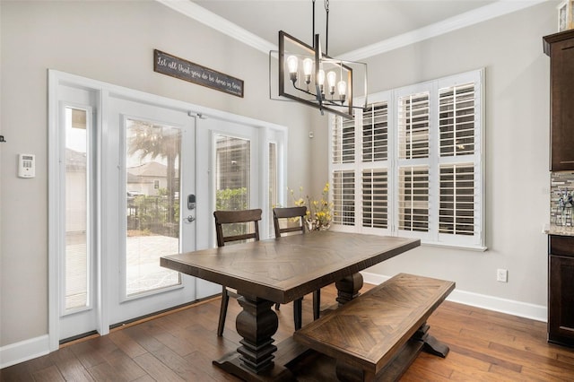 2898 SW 117th Way, Gainesville, FL 32608 - dining area with ornamental molding, french doors, a chandelier, baseboards, and wood-type flooring