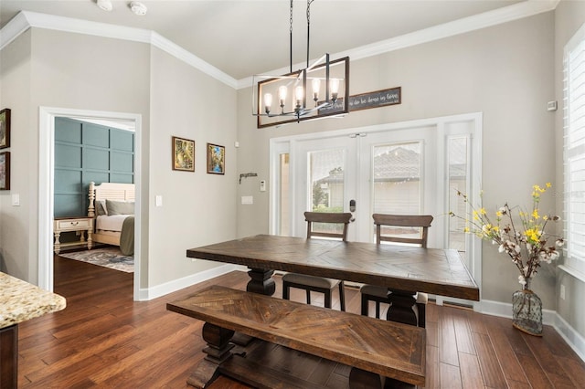 2898 SW 117th Way, Gainesville, FL 32608 - dining space with baseboards, dark wood-type flooring, ornamental molding, a chandelier, and a towering ceiling