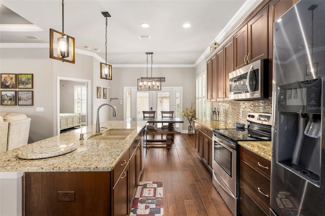 2898 SW 117th Way, Gainesville, FL 32608 - kitchen with appliances with stainless steel finishes, a sink, decorative backsplash, an island with sink, and dark wood finished floors