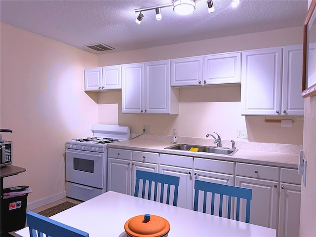 1700 SW 16th Ct Unit J22, Gainesville, FL 32608 - kitchen with a sink, white gas range, light countertops, white cabinets, and a textured ceiling