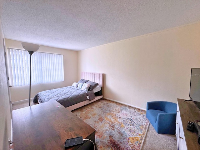 1700 SW 16th Ct Unit J22, Gainesville, FL 32608 - carpeted bedroom with a textured ceiling and baseboards