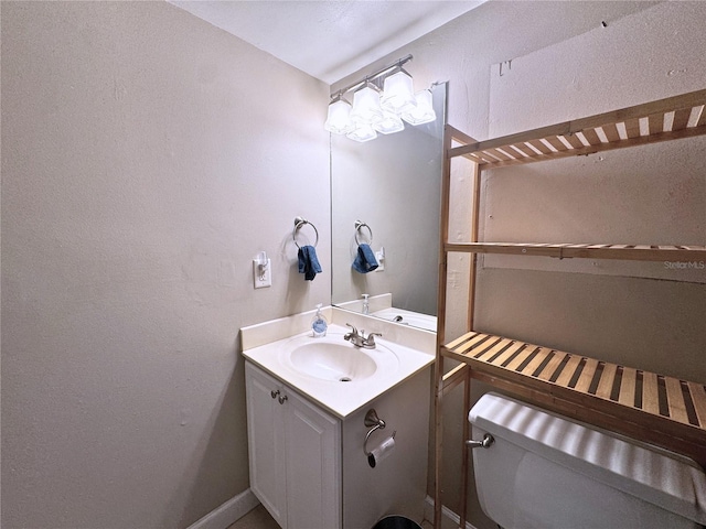 1700 SW 16th Ct Unit J22, Gainesville, FL 32608 - half bathroom featuring vanity, toilet, and a textured wall