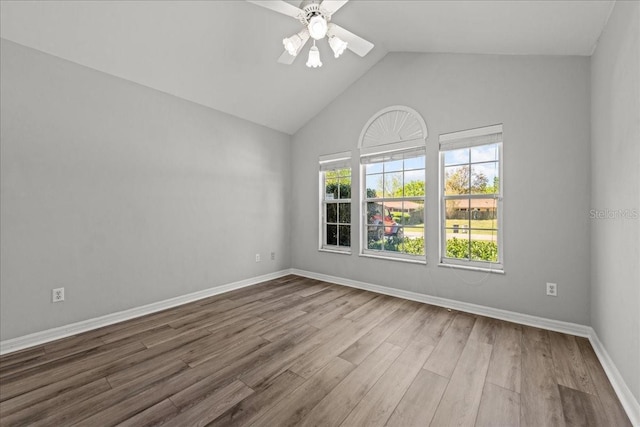 11737 Creek Dr, Alachua, FL 32615 - empty room featuring wood finished floors, a ceiling fan, baseboards, and high vaulted ceiling