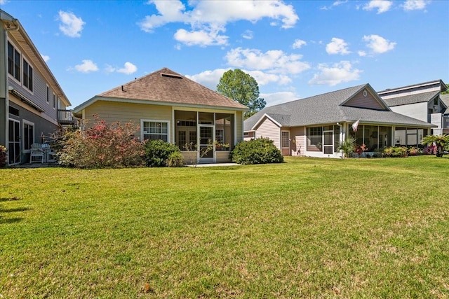 11737 Creek Dr, Alachua, FL 32615 - back of house with a sunroom, a lawn, and a shingled roof