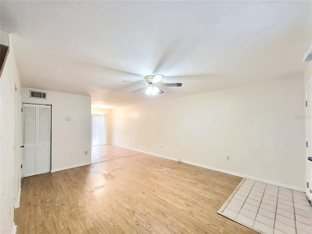 2300 SW 43rd St Unit L2, Gainesville, FL 32607 - empty room featuring ceiling fan, light wood-type flooring, and baseboards