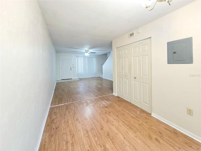 2300 SW 43rd St Unit L2, Gainesville, FL 32607 - unfurnished bedroom with electric panel, light wood-style flooring, baseboards, a closet, and a ceiling fan