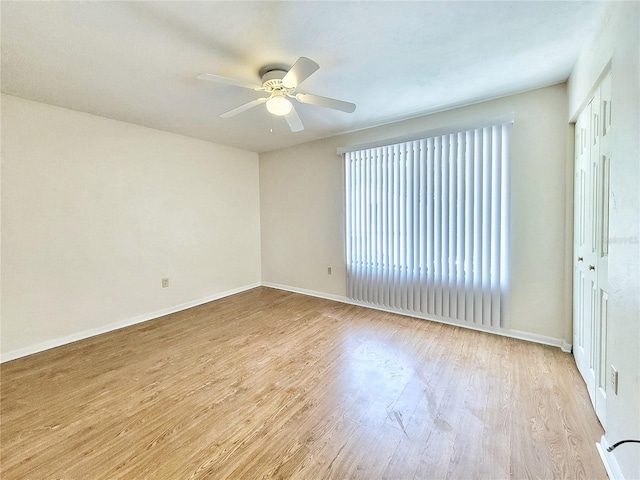 2300 SW 43rd St Unit L2, Gainesville, FL 32607 - spare room with wood finished floors, ceiling fan, and baseboards