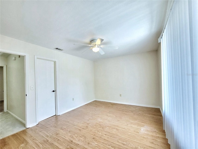 2300 SW 43rd St Unit L2, Gainesville, FL 32607 - spare room featuring a ceiling fan, light wood-type flooring, and baseboards