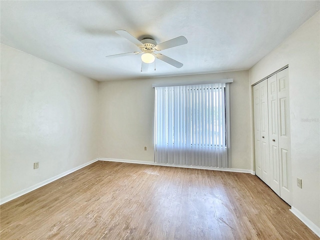 2300 SW 43rd St Unit L2, Gainesville, FL 32607 - unfurnished bedroom with wood finished floors, baseboards, a closet, and ceiling fan