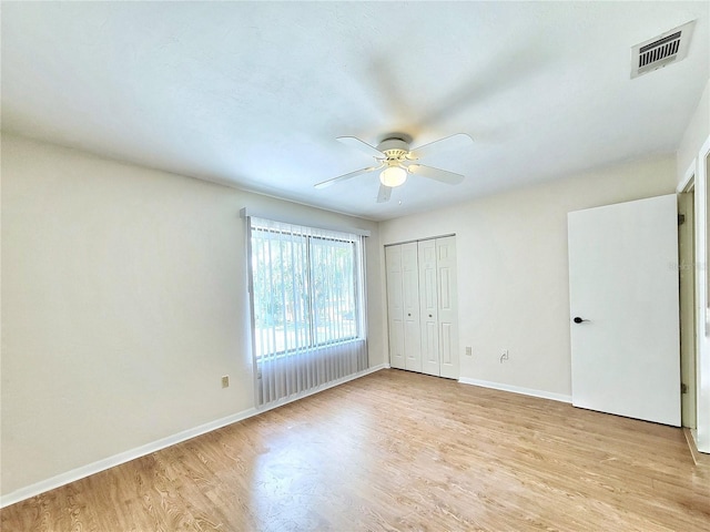 2300 SW 43rd St Unit L2, Gainesville, FL 32607 - unfurnished bedroom featuring light wood finished floors, baseboards, a closet, and a ceiling fan