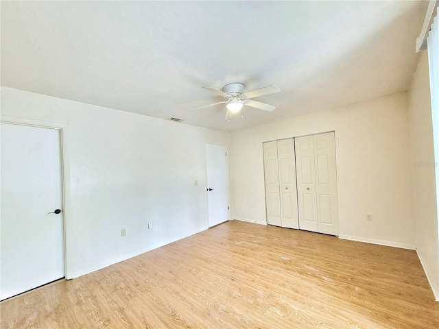 2300 SW 43rd St Unit L2, Gainesville, FL 32607 - unfurnished bedroom with light wood-type flooring, baseboards, a closet, and a ceiling fan
