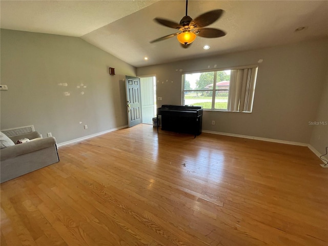 395 SW Grove St, Keystone Heights, FL 32656 - living room with a ceiling fan, light wood-type flooring, lofted ceiling, and baseboards