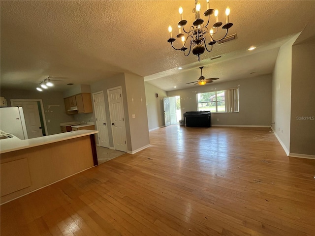395 SW Grove St, Keystone Heights, FL 32656 - unfurnished living room featuring a ceiling fan, light wood-style floors, a textured ceiling, a chandelier, and baseboards