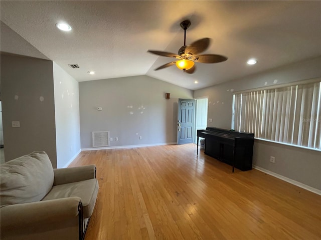 395 SW Grove St, Keystone Heights, FL 32656 - living room with lofted ceiling, a ceiling fan, baseboards, and light wood finished floors