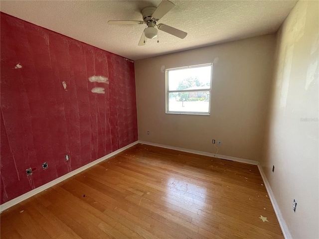 395 SW Grove St, Keystone Heights, FL 32656 - unfurnished room with wood finished floors, ceiling fan, baseboards, and a textured ceiling