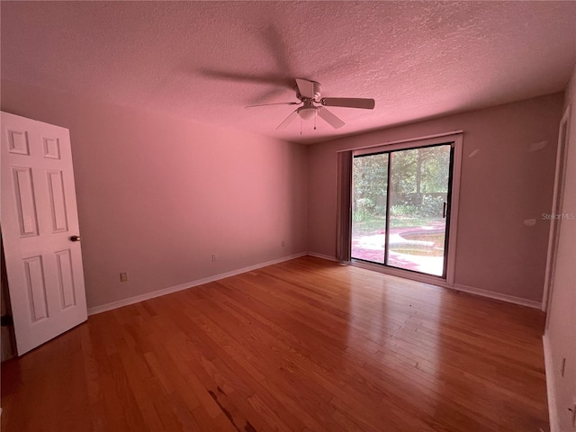 395 SW Grove St, Keystone Heights, FL 32656 - unfurnished room with a textured ceiling, wood finished floors, a ceiling fan, and baseboards