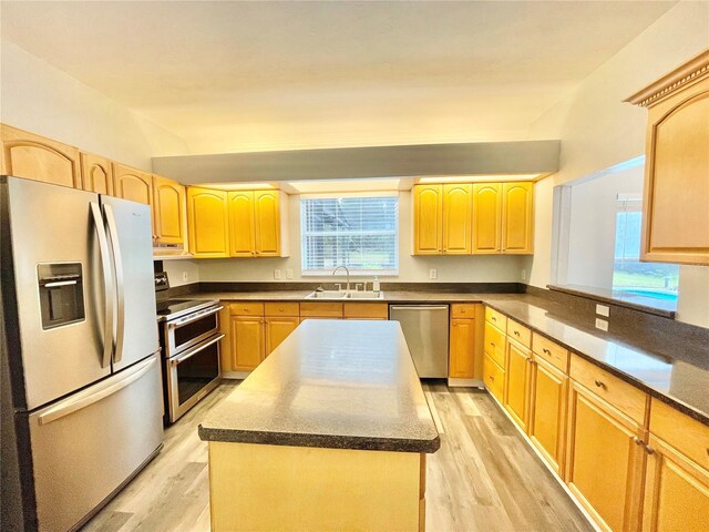 5510 NW 80th Ave, Gainesville, FL 32653 - kitchen featuring appliances with stainless steel finishes, a sink, light brown cabinetry, and light wood-style floors