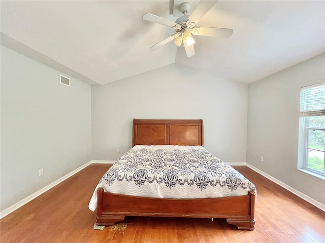 5510 NW 80th Ave, Gainesville, FL 32653 - bedroom featuring lofted ceiling, wood finished floors, baseboards, and a ceiling fan