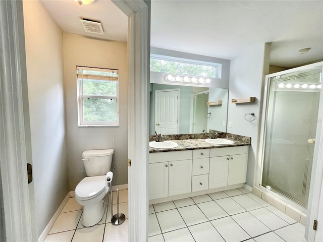 5510 NW 80th Ave, Gainesville, FL 32653 - full bath with double vanity, a shower stall, toilet, tile patterned floors, and baseboards