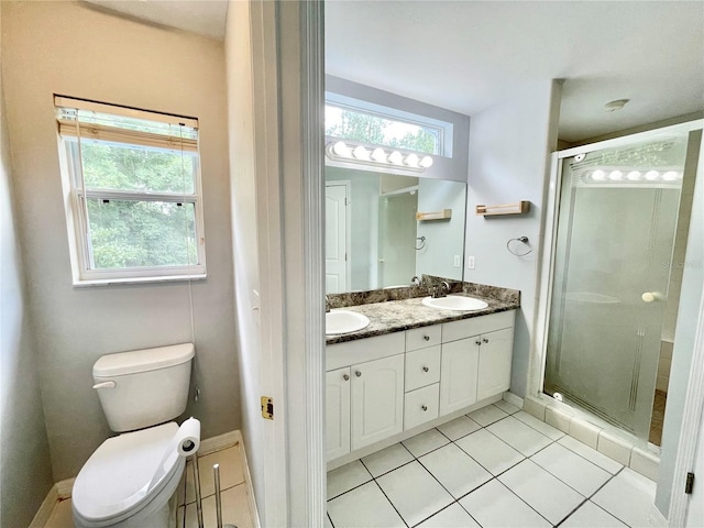 5510 NW 80th Ave, Gainesville, FL 32653 - full bathroom featuring double vanity, a stall shower, tile patterned flooring, and toilet