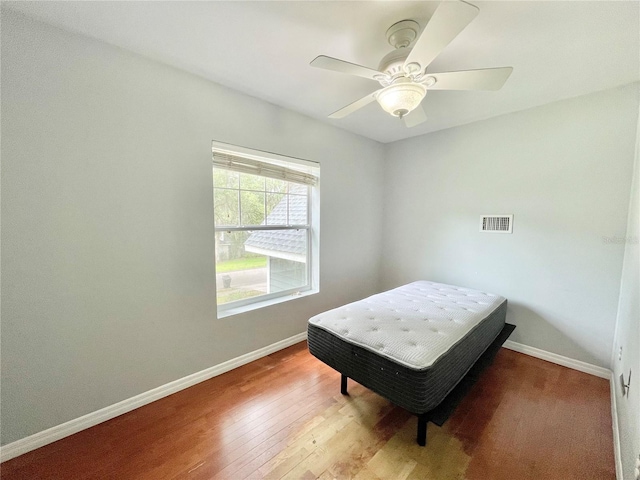 5510 NW 80th Ave, Gainesville, FL 32653 - bedroom featuring wood finished floors, baseboards, and ceiling fan