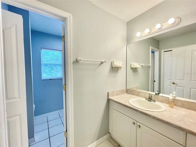 5510 NW 80th Ave, Gainesville, FL 32653 - bathroom featuring vanity, tile patterned floors, and baseboards