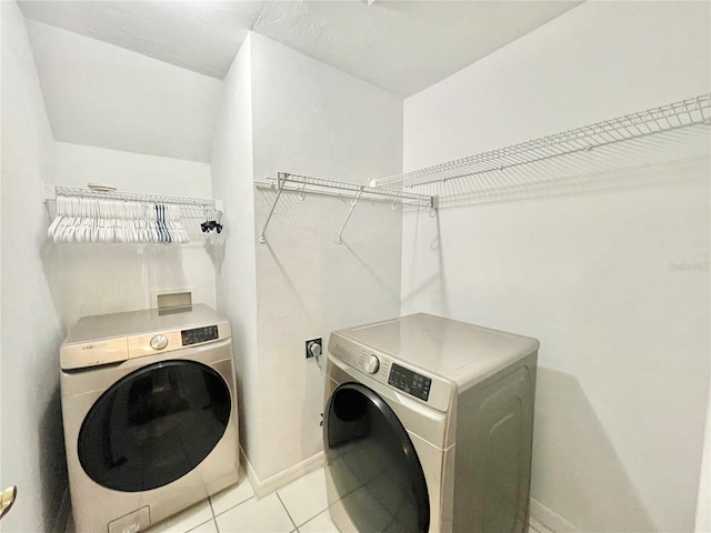 5510 NW 80th Ave, Gainesville, FL 32653 - laundry area featuring separate washer and dryer, light tile patterned flooring, and baseboards