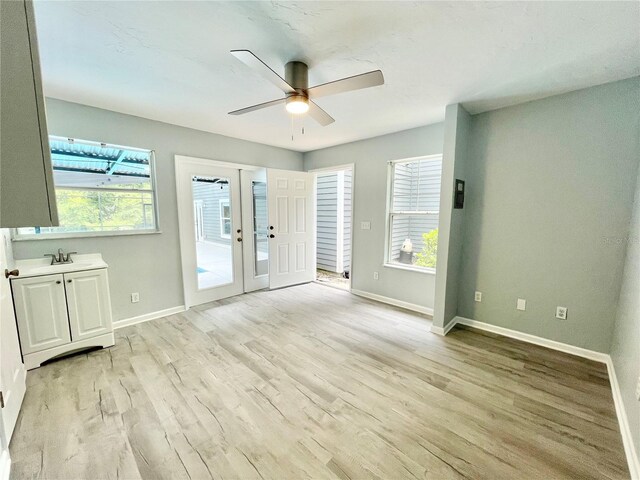 5510 NW 80th Ave, Gainesville, FL 32653 - unfurnished room featuring a ceiling fan, light wood finished floors, healthy amount of natural light, and baseboards