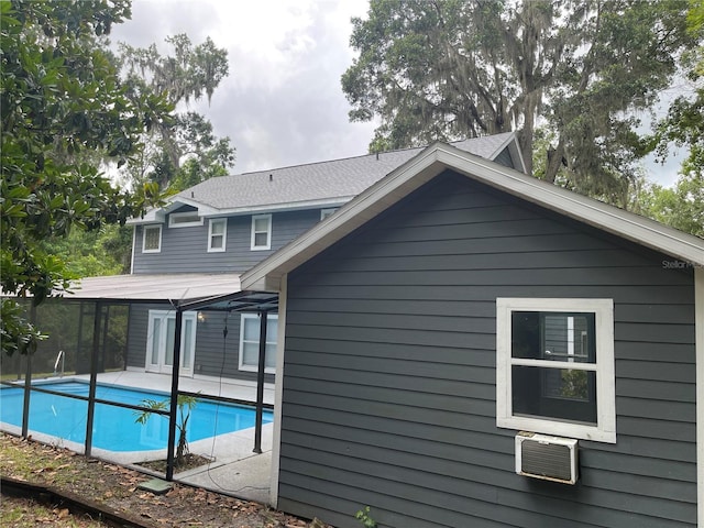 5510 NW 80th Ave, Gainesville, FL 32653 - back of house featuring an outdoor pool, a wall unit AC, and a patio area