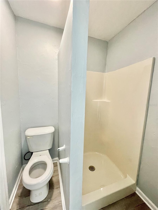5510 NW 80th Ave, Gainesville, FL 32653 - bathroom featuring toilet, a shower stall, and baseboards
