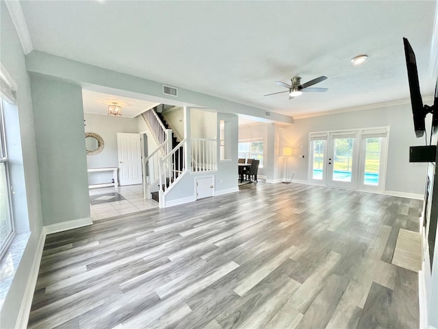 5510 NW 80th Ave, Gainesville, FL 32653 - unfurnished living room with stairway, wood finished floors, ornamental molding, a ceiling fan, and baseboards