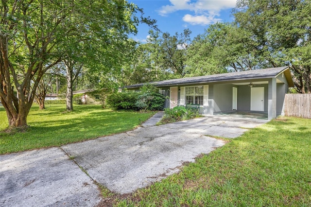 5806 NW 26th Ter, Gainesville, FL 32653 - ranch-style house featuring concrete driveway, an attached carport, and a shingled roof