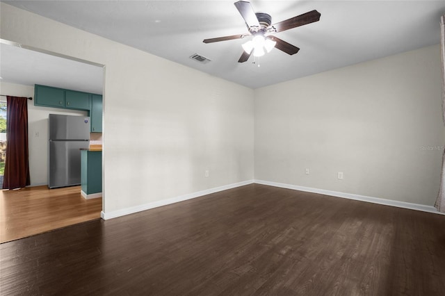 5806 NW 26th Ter, Gainesville, FL 32653 - spare room with dark wood-style floors, a ceiling fan, and baseboards