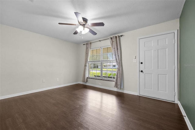 5806 NW 26th Ter, Gainesville, FL 32653 - spare room with a ceiling fan, dark wood finished floors, and baseboards