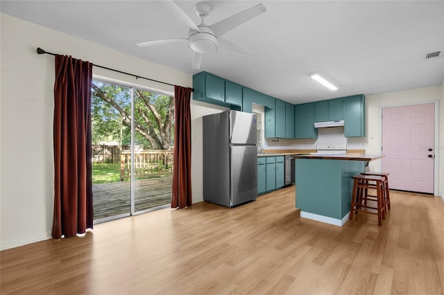 5806 NW 26th Ter, Gainesville, FL 32653 - kitchen featuring freestanding refrigerator, under cabinet range hood, light wood-style floors, a center island, and a ceiling fan