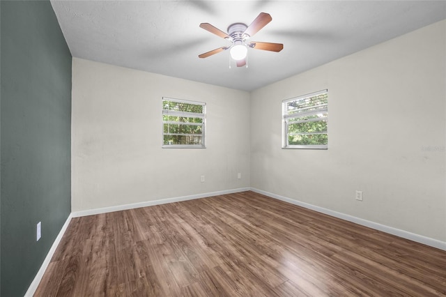 5806 NW 26th Ter, Gainesville, FL 32653 - empty room with wood finished floors, baseboards, and a ceiling fan