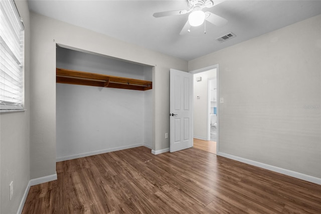 5806 NW 26th Ter, Gainesville, FL 32653 - unfurnished bedroom featuring wood finished floors, baseboards, and ceiling fan