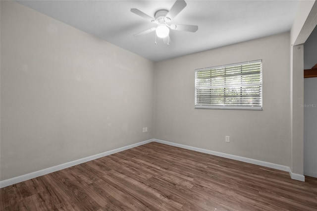 5806 NW 26th Ter, Gainesville, FL 32653 - empty room featuring wood finished floors, ceiling fan, and baseboards
