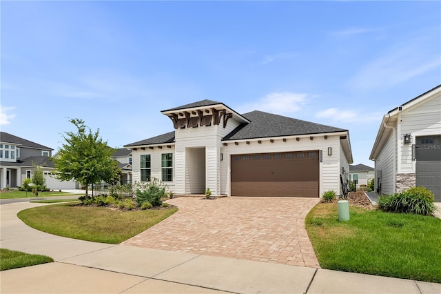 3225 SW 120th Ter, Gainesville, FL 32608 - view of front of property with a shingled roof, an attached garage, decorative driveway, and a front lawn