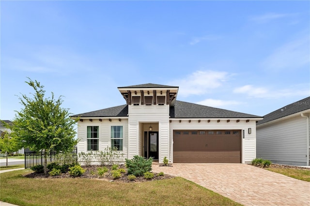 3225 SW 120th Ter, Gainesville, FL 32608 - view of front of house with an attached garage, decorative driveway, and a shingled roof