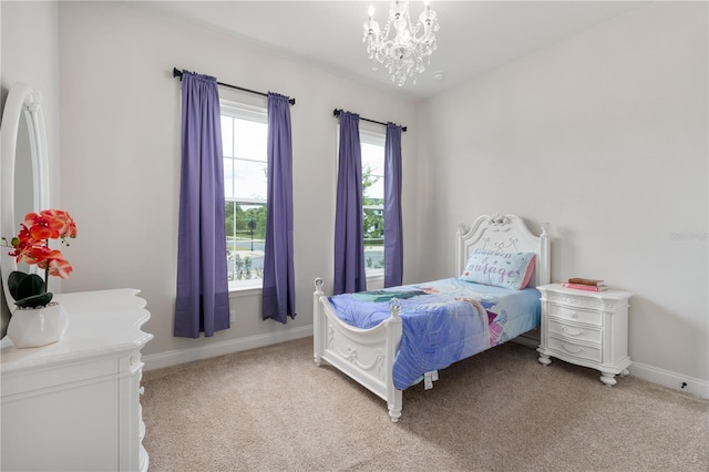 3225 SW 120th Ter, Gainesville, FL 32608 - bedroom featuring light carpet, baseboards, and a chandelier