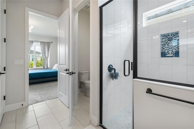 3225 SW 120th Ter, Gainesville, FL 32608 - ensuite bathroom featuring toilet, a shower stall, baseboards, and tile patterned floors
