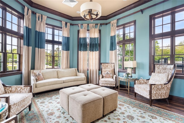 3225 SW 120th Ter, Gainesville, FL 32608 - living area with ornamental molding, a chandelier, a towering ceiling, and wood finished floors