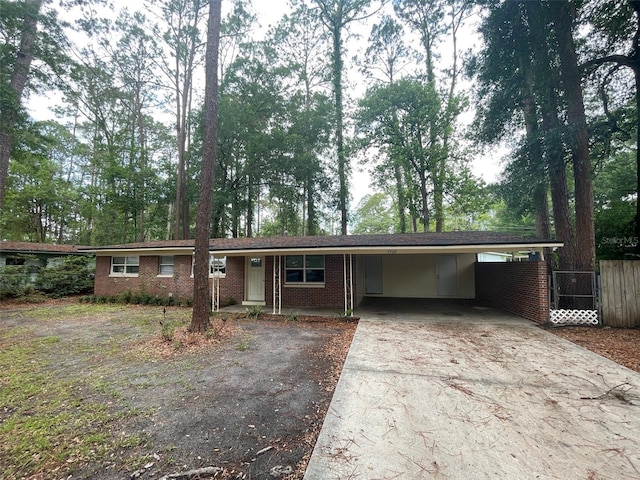 1702 NE 15th Ter, Gainesville, FL 32609 - single story home featuring driveway, brick siding, a carport, and view of scattered trees