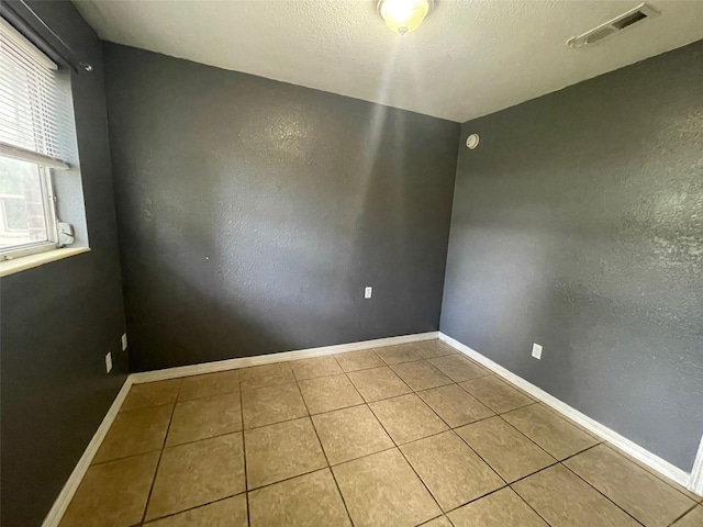 1702 NE 15th Ter, Gainesville, FL 32609 - tiled empty room with baseboards