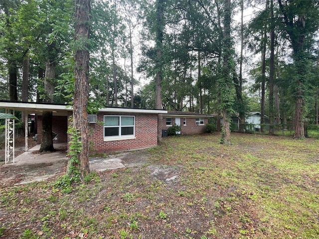1702 NE 15th Ter, Gainesville, FL 32609 - back of house featuring brick siding and an attached carport