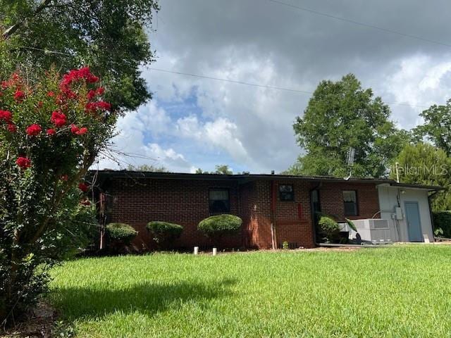 16431 NW US Highway 441, Alachua, FL 32615 - single story home with a front yard and brick siding