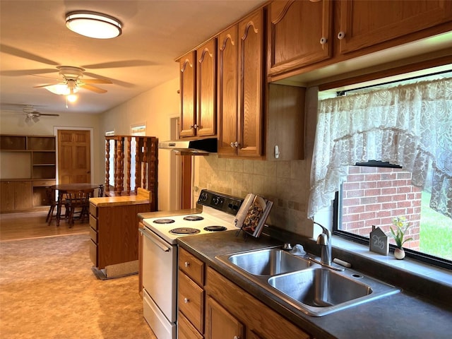 16431 NW US Highway 441, Alachua, FL 32615 - kitchen featuring white electric range, a sink, brown cabinets, a ceiling fan, and decorative backsplash