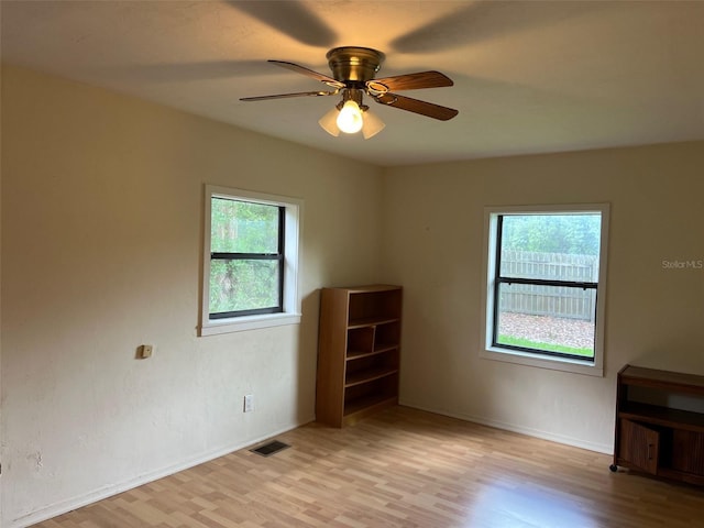 16431 NW US Highway 441, Alachua, FL 32615 - empty room with plenty of natural light, light wood-type flooring, and a ceiling fan