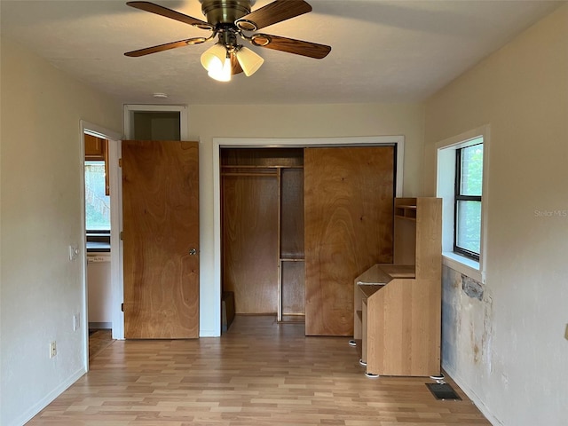 16431 NW US Highway 441, Alachua, FL 32615 - unfurnished bedroom featuring light wood-type flooring, a closet, ceiling fan, and baseboards